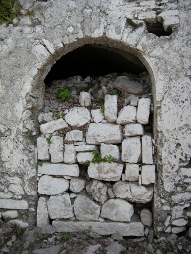An old stone doorway obstructed by stone blocks
