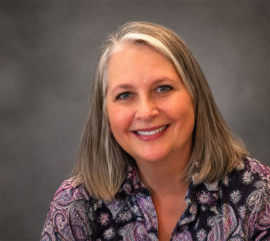 An image of woman with a house background